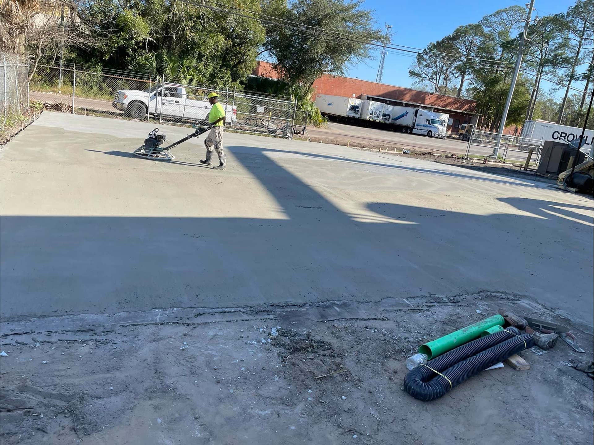 Worker from Ernest Concrete working on new concrete parking lot