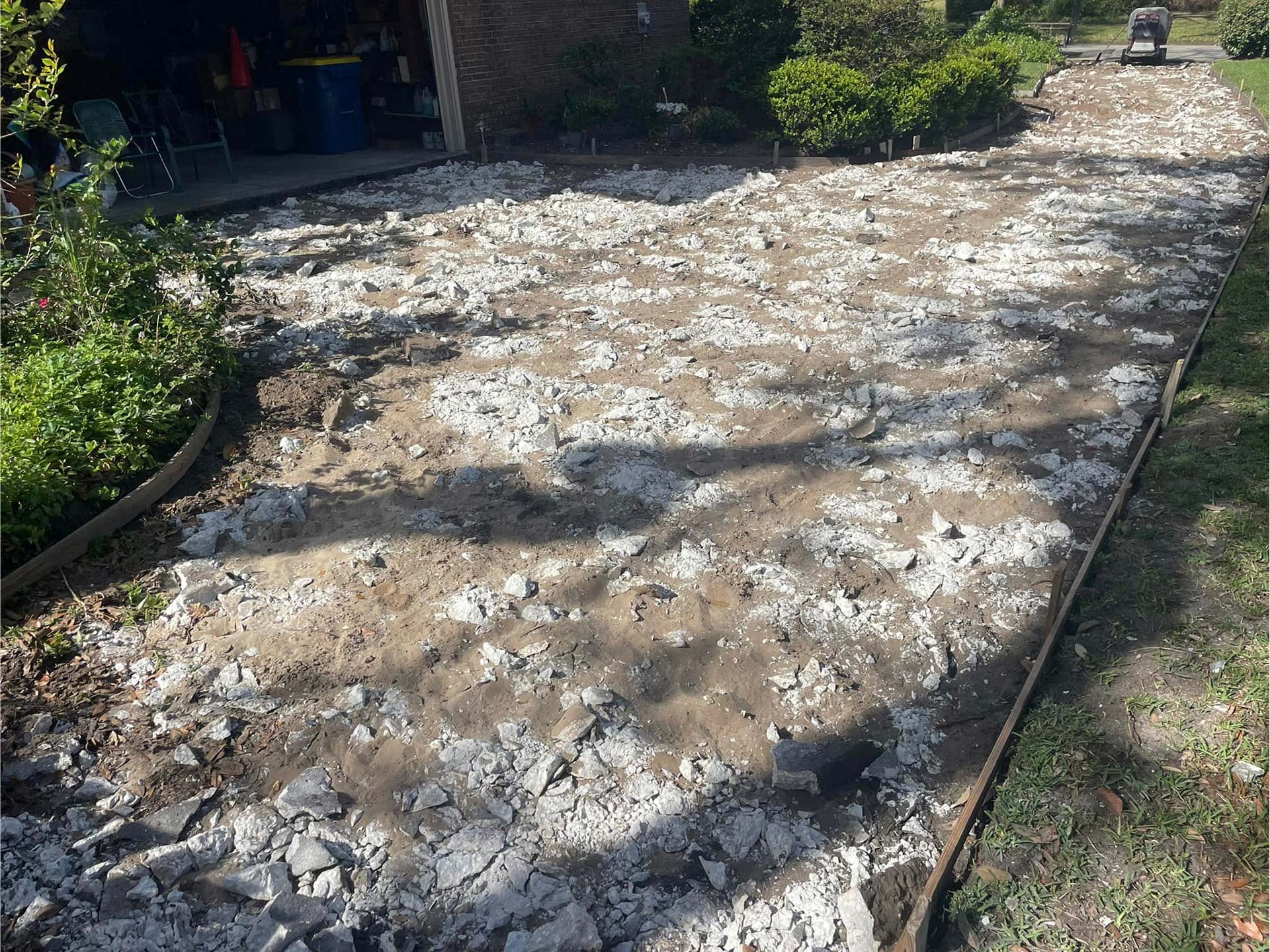 Old concrete driveway being torn up, prepared for new concrete driveway installation