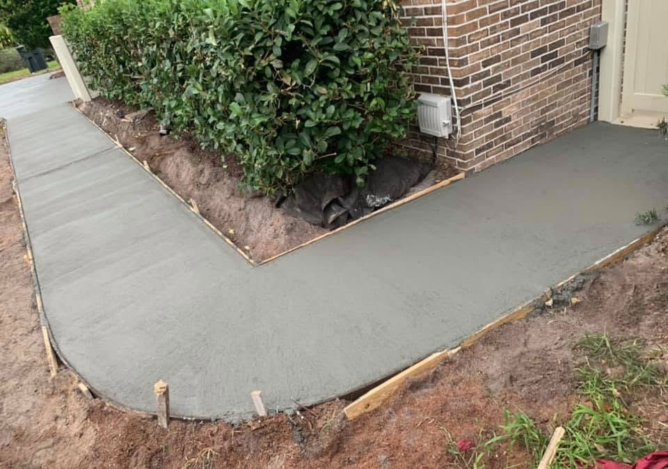 In-progress concrete walkway installation